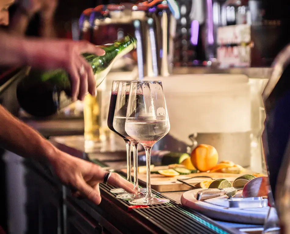 Drinks being poured into glasses at the bar